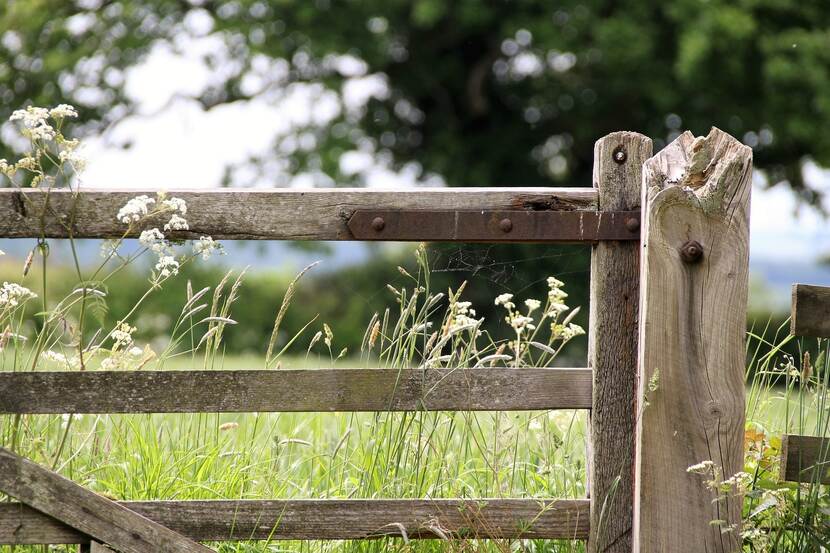 A rustic wooden farm gate in a rural environment