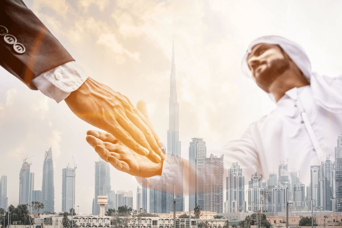 overlay of shaking hands over city in the Gulf region