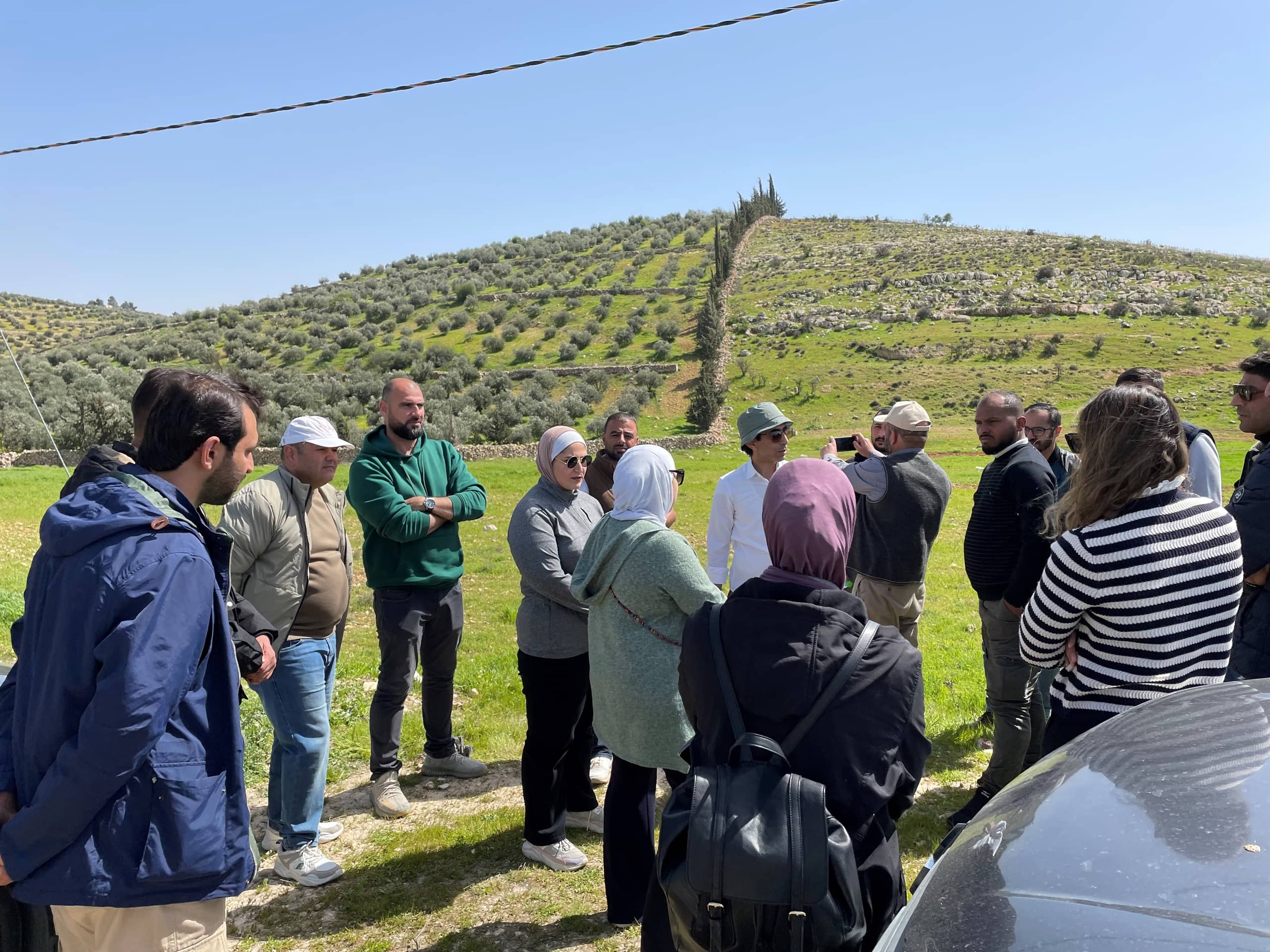 group standing in front of hill