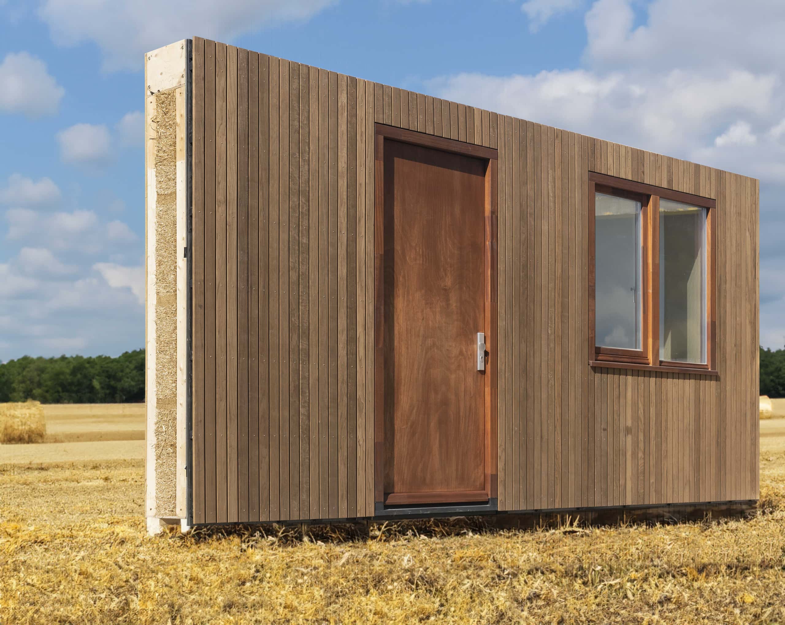 wooden facade in a field of hay