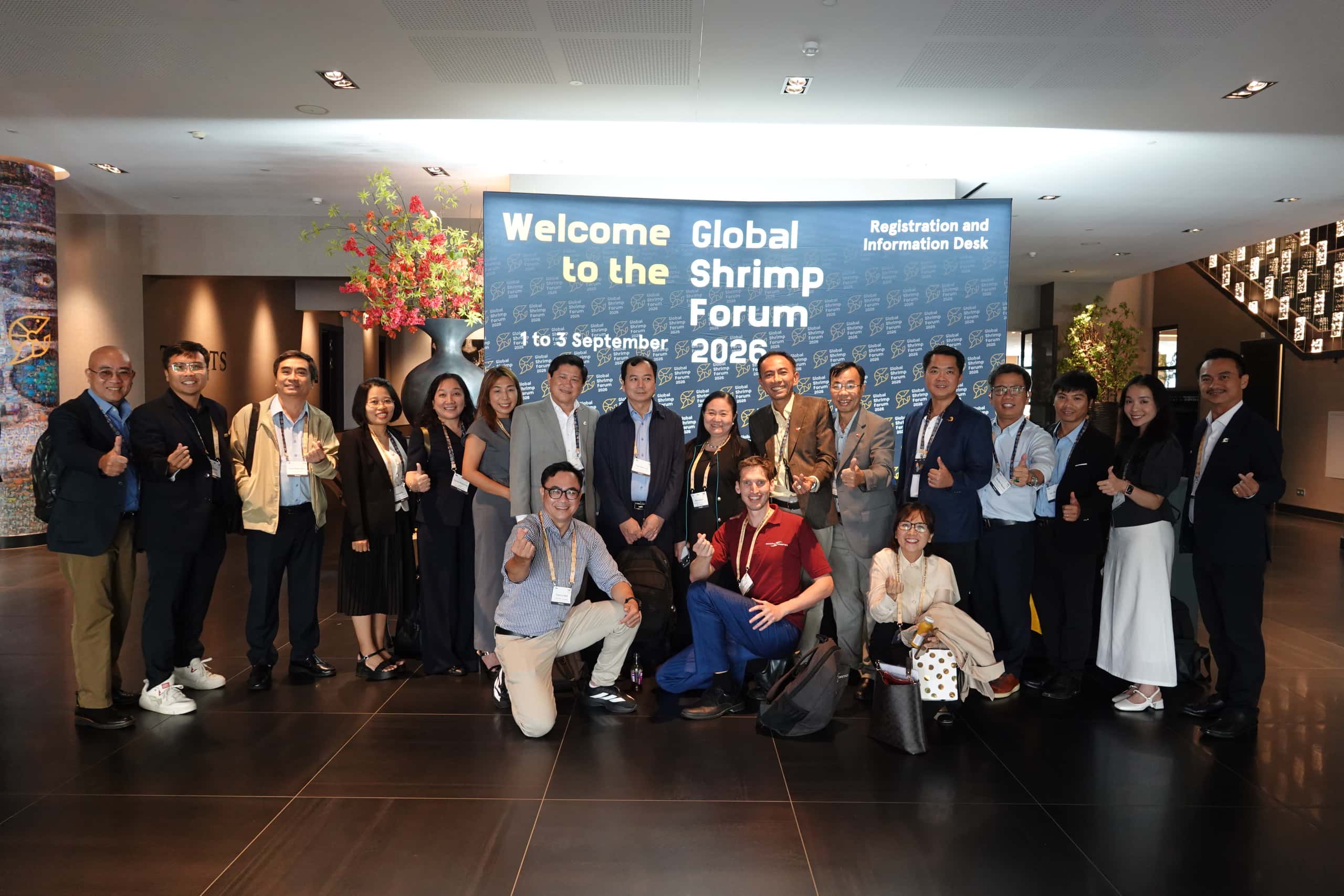 group photo 15 people, text "Global Shrimp Forum 2026"