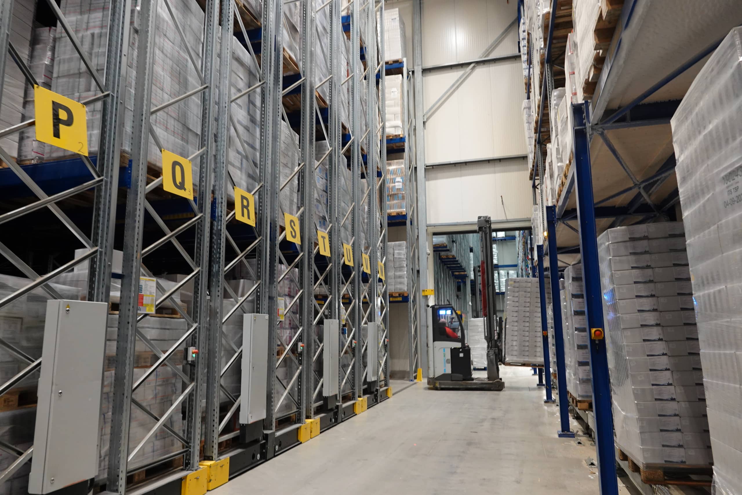 multiple rows of big boxes of goods inside a storage
