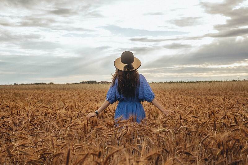 A woman walking in a wheat field