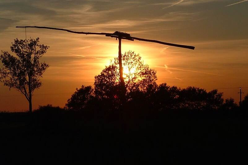 A shadoof is seen agaisnt the backgrop of the setting sun on the Hungarian Great Plains.