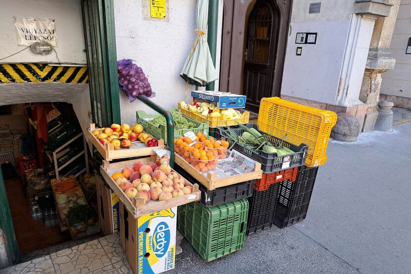 Vegetables in plastic and wooden crates outside a grocery store on the street in Budapest, Hungary