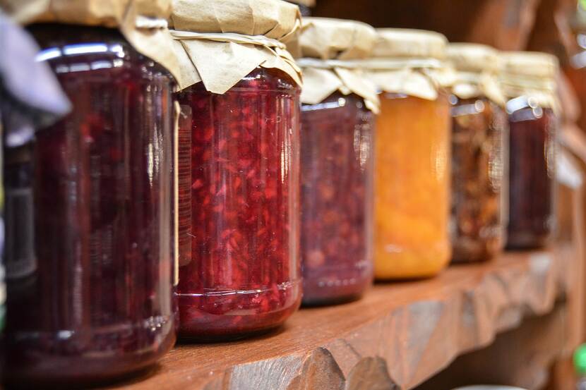 Close-up pictures of jars if fruit jam on a shelf
