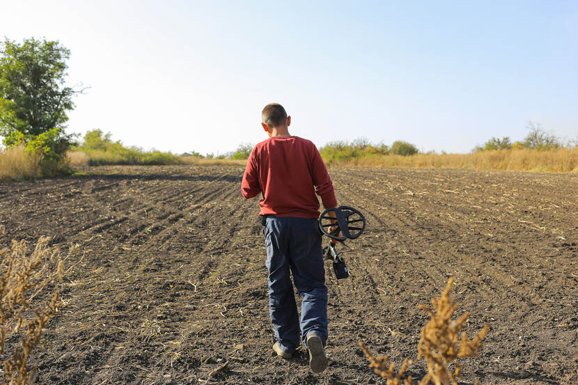 A farmer with a metal detector during the demining of a field.  Kharkiv region. 4 October