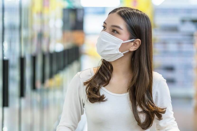 lady wearing a face mask looking in her right