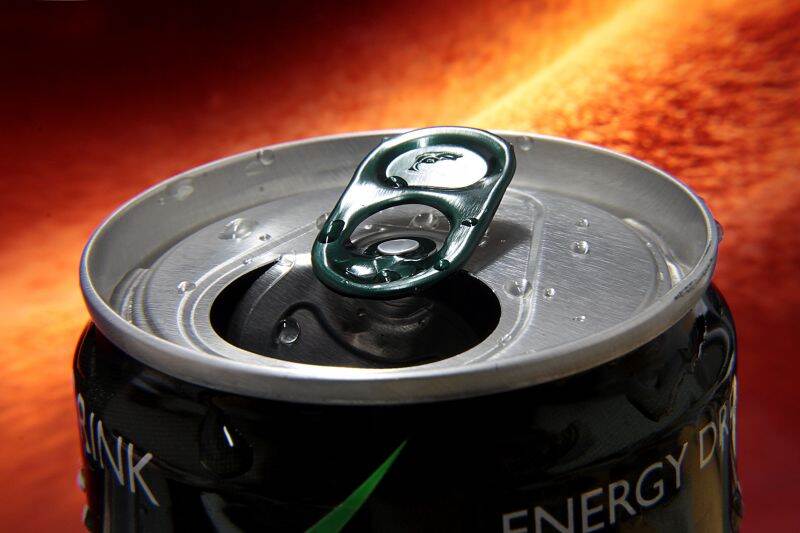 open can with an energy dring and an orange energetic background