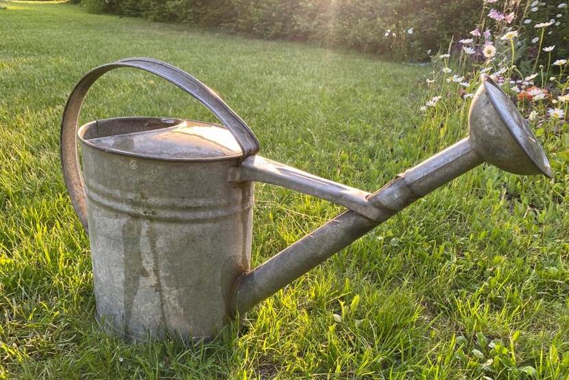 watering can in the sun rays