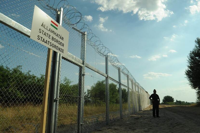 Border fence between Hungary and Serbia with barbed wire on the top.