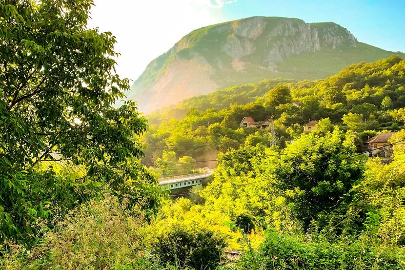 Rural landscape in serbia with a dramatic hilltop and verdant green forests.