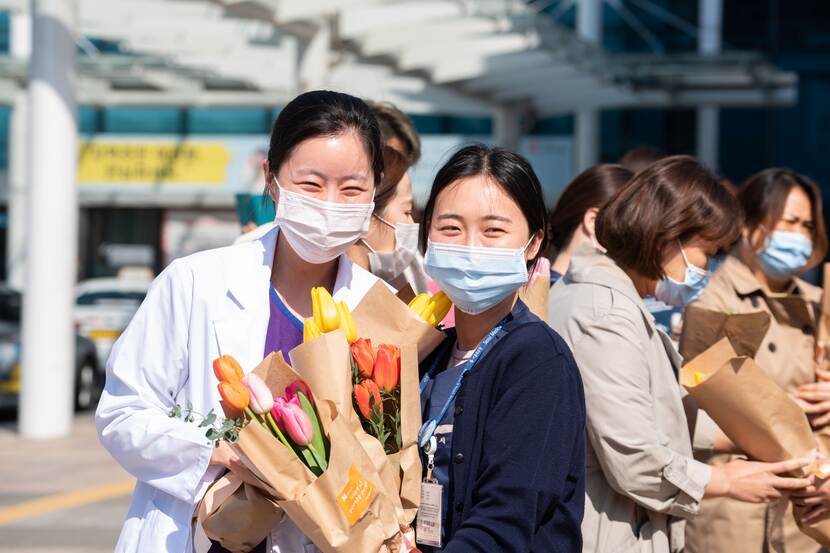Medical staffs with tulip bouquets